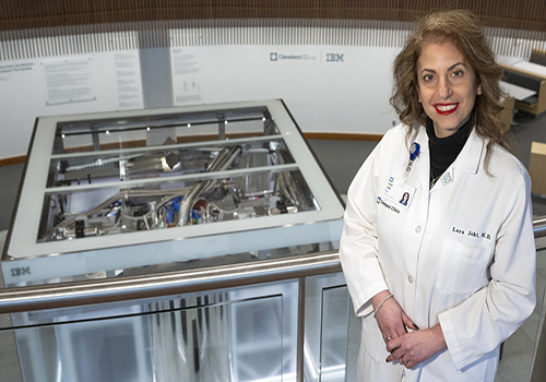 Dr. Jehi standing on walkway above quantum computer